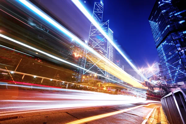 Traffic light trails in modern city street — Stock Photo, Image