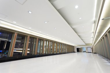 Empty corridor in modern commercial building clipart