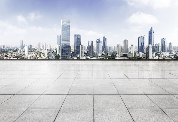 Empty floor with modern skyline and buildings