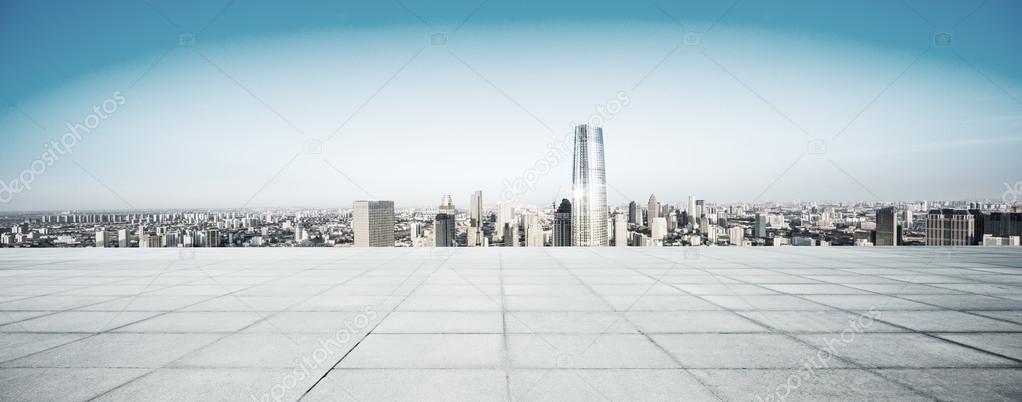 Empty floor and modern city skyline