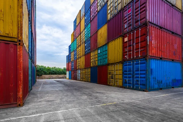 Stack of containers with empty road in front — Stock Photo, Image