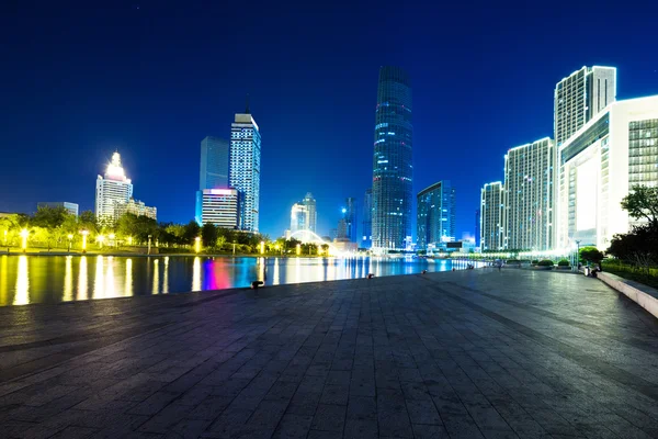Illumintaed modern skyscrapers and skyline at riverbank