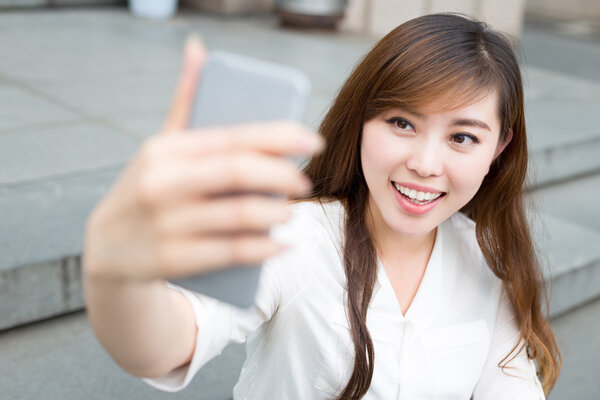 woman using mobile phone to take selfie 