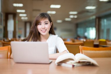 kız öğrenci kitaplığı dizüstü bilgisayar ile eğitim