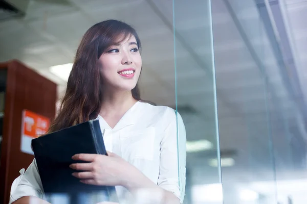 Asian female student holding book in library — Stock Photo, Image
