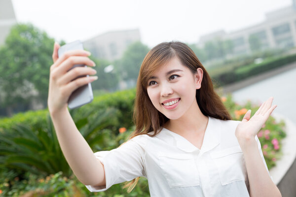 woman using mobile phone to take selfie 