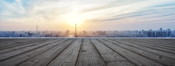 Panoramic skyline and buildings with empty wooden board — Stock Photo, Image