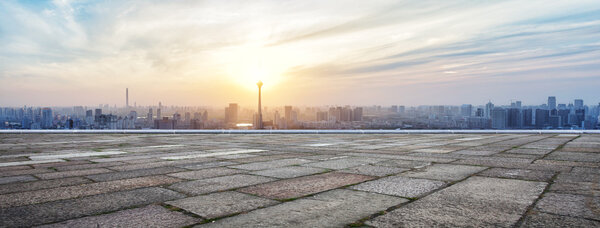 Panoramic skyline and buildings with empty brick square