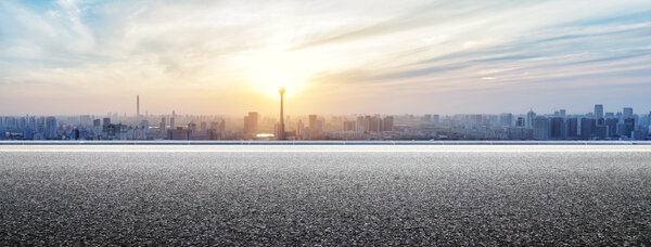 Panoramic skyline and buildings with empty road