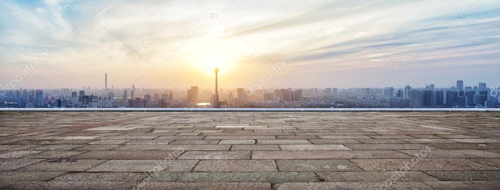 Panoramic skyline and buildings with empty brick square