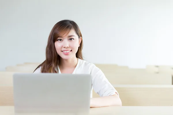 Vrouwelijke student studeert met laptop in de klas — Stockfoto