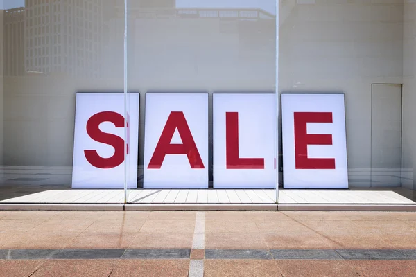 Sale poster in shop display window — Stock Photo, Image