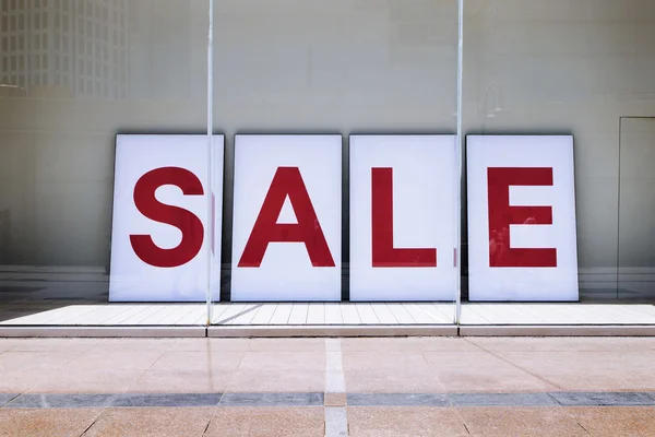 Sale poster in shop display window — Stock Photo, Image