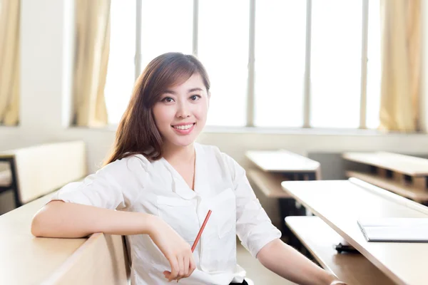 Asian female student studying in classroom — Stock Photo, Image