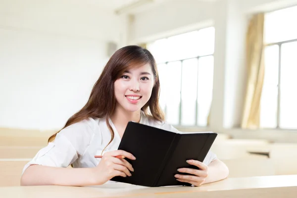 Asiatisk kvindelig studerende studerer i klasseværelset - Stock-foto