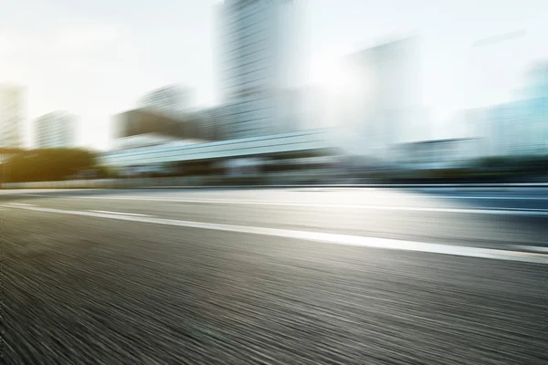 Blurred motion of modern skyline and urban street — Stock Photo, Image