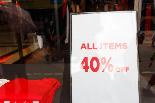 Sale sign in clothes shop — Stock Photo, Image