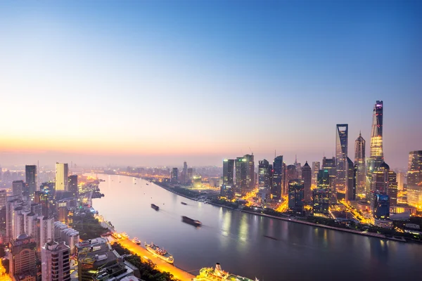 Skyscrapers of the city in China around a river at dusk — Stock Photo, Image