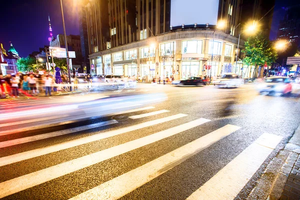 Crowded road with zebra crossing and gymnasium — Stock Photo, Image