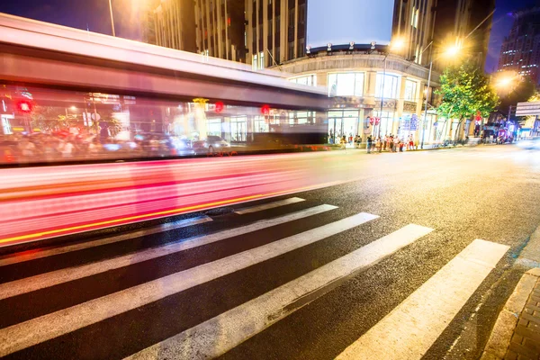 Crowded road with zebra crossing and gymnasium — Stock Photo, Image