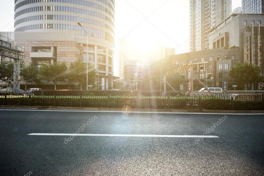 empty asphalt road in modern city under twilight