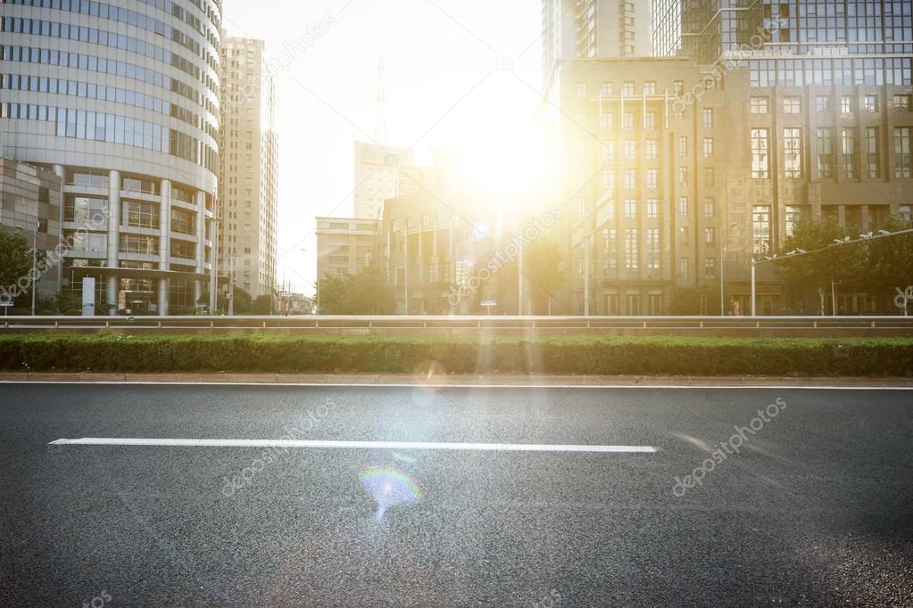 empty asphalt road in modern city under twilight