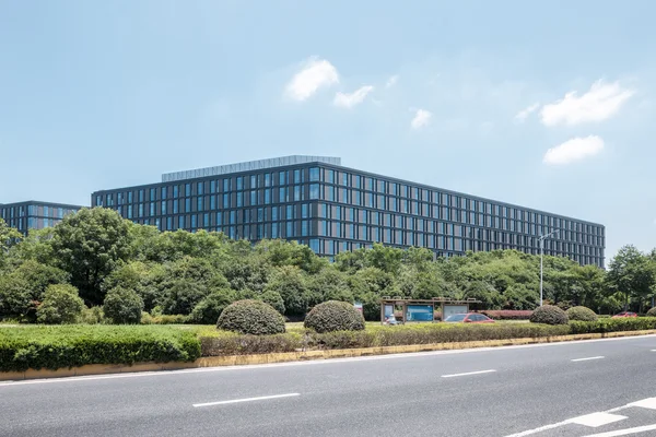 Modernes Bürogebäude mit leerer Straße davor — Stockfoto