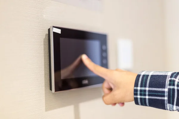 Finger touching screen on wall — Stock Photo, Image