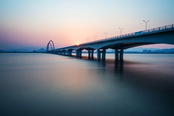 Skyline and bridge over river — Stock Photo, Image