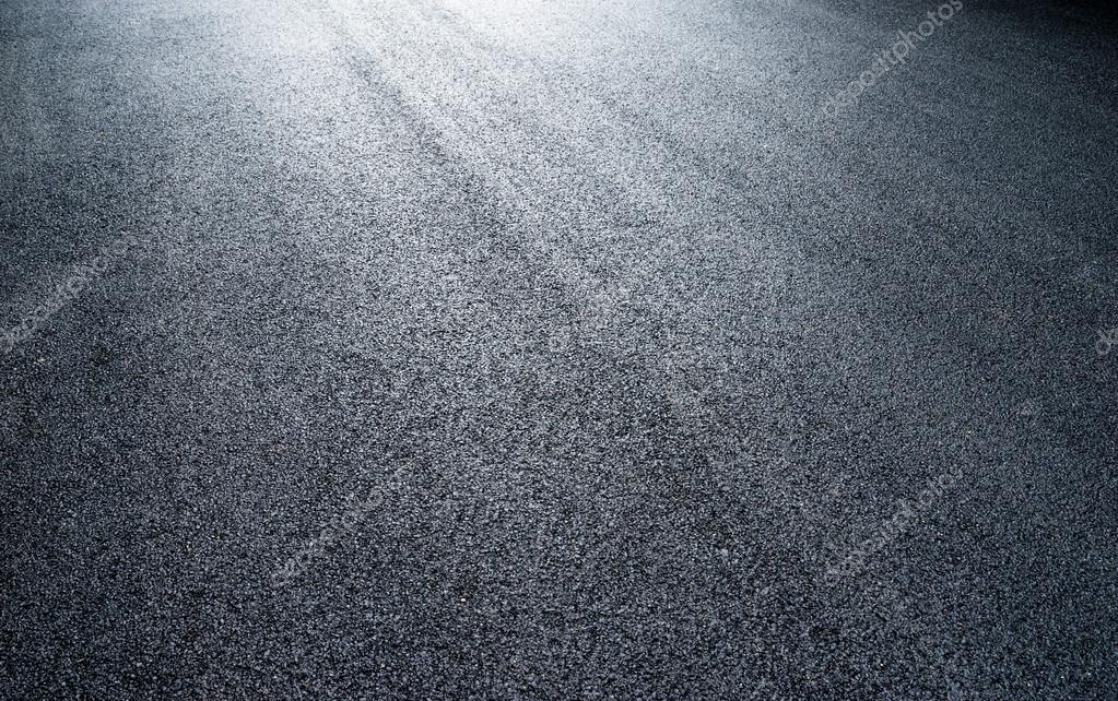 Asphalt road under light
