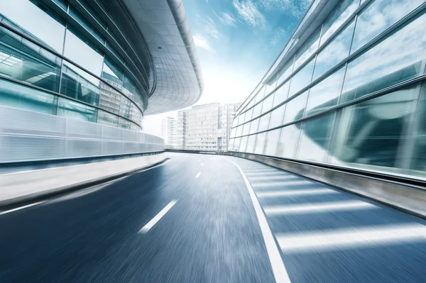 Skyline and empty road by modern buildings — Stock Photo, Image