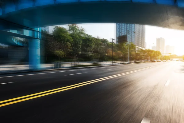 Sunrise skyline and road through bridge — Stock Photo, Image