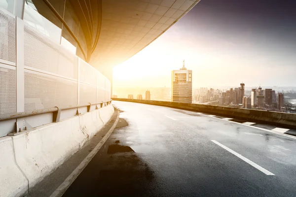 Empty road and modern building sunlight skyline — Stock Photo, Image