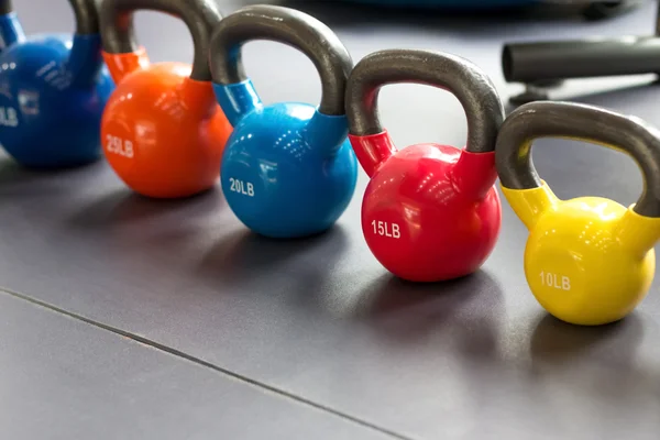 Colorful kettlebells in gym or sport club — Stock Photo, Image