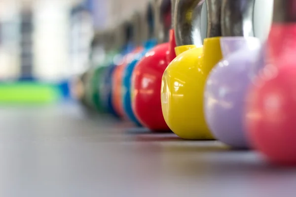 Colorful kettlebells in gym or sport club — Stock Photo, Image