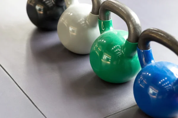 Colorful kettlebells in gym or sport club — Stock Photo, Image