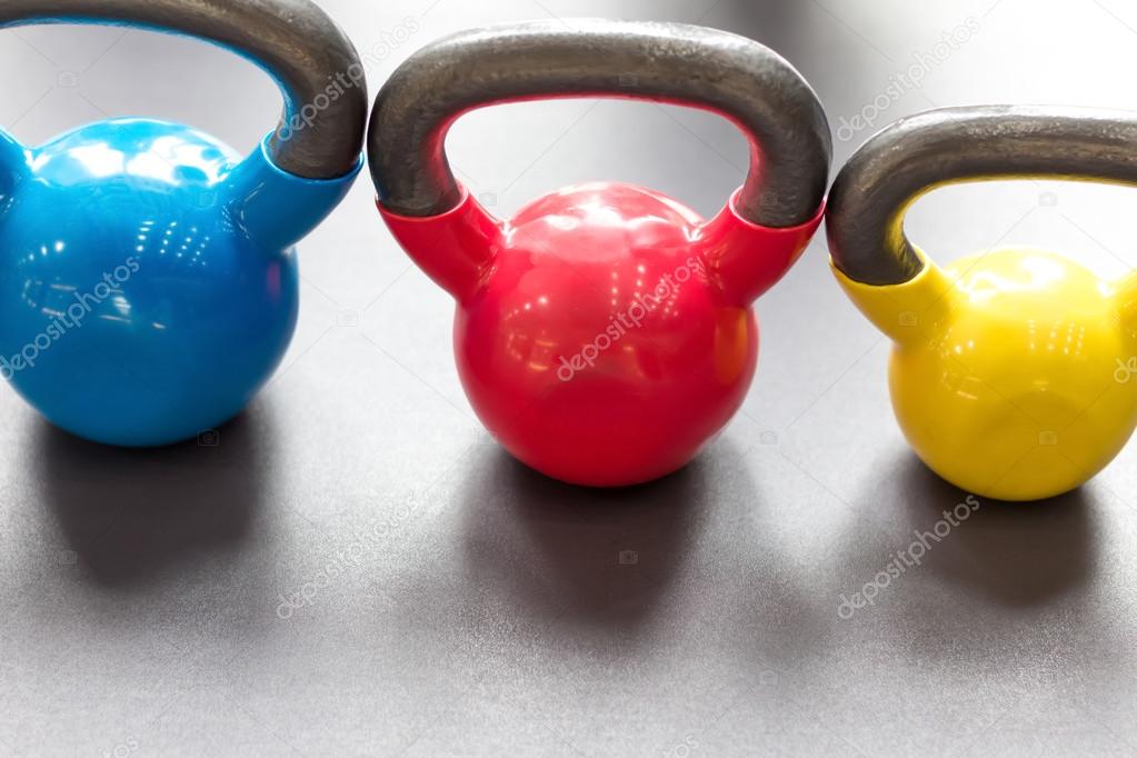 colorful kettlebells in gym or sport club