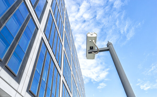 spy on pole near modern building