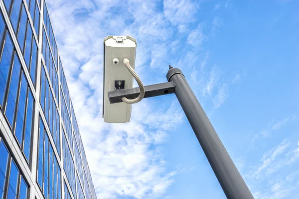 Spy on pole near modern building — Stock Photo, Image