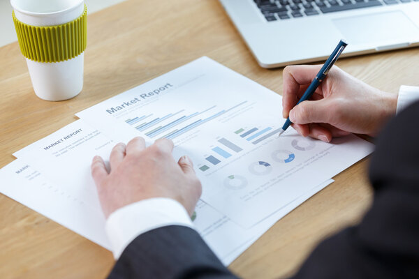 businessman checking financial report on table