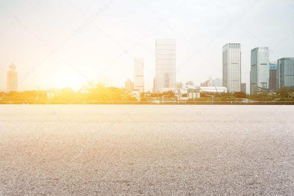 floor with modern cityscape at sunrise time