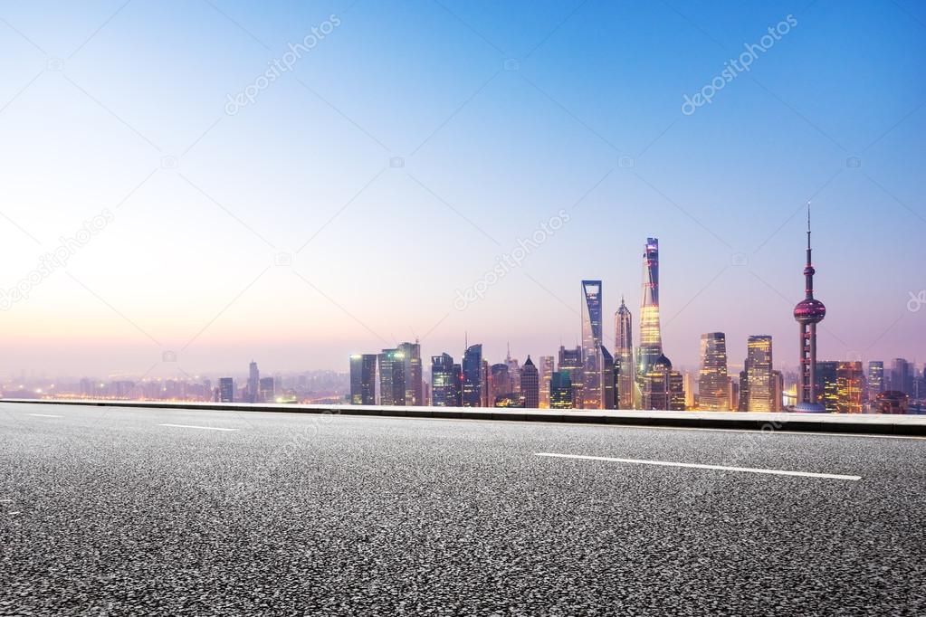 empty asphalt road and cityscape