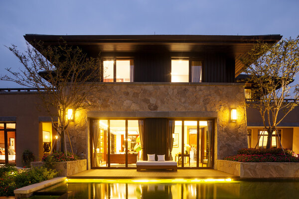exterior of modern building near pond at night