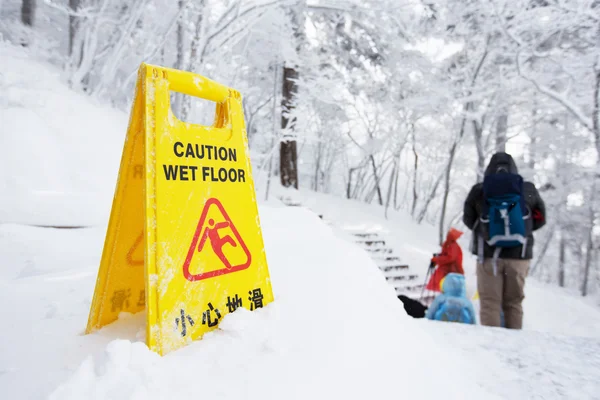 Ostrzeżenie przestroga znak pokładzie na śniegu — Zdjęcie stockowe