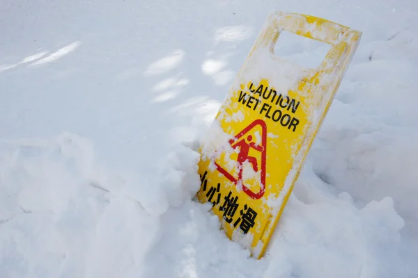 Warning caution sign board on snow floor — Stock Photo, Image