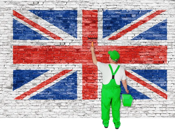 Professional house painter covers wall with british flag — Stock Photo, Image