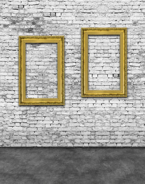 Two vertical golden frames on brick wall — Stock Photo, Image