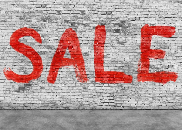 Sale word painted on white wall Stock Photo