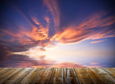 Empty wooden deck table with dusk sky background