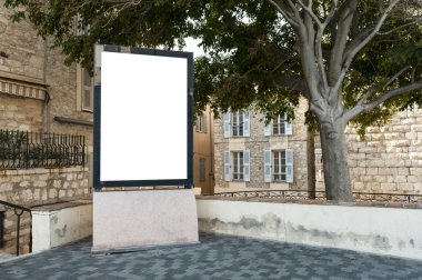 Vertical billboard in a place under a tree